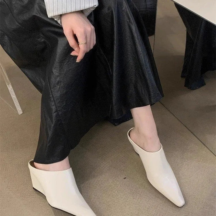 Women's black wind wedge closed toe half slippers made of PU material.