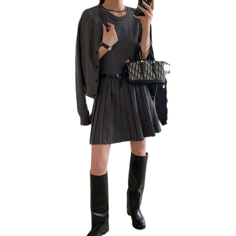 Grey art retro knitted two-piece set for women, showing a vest skirt and long-sleeved cardigan with a belt.