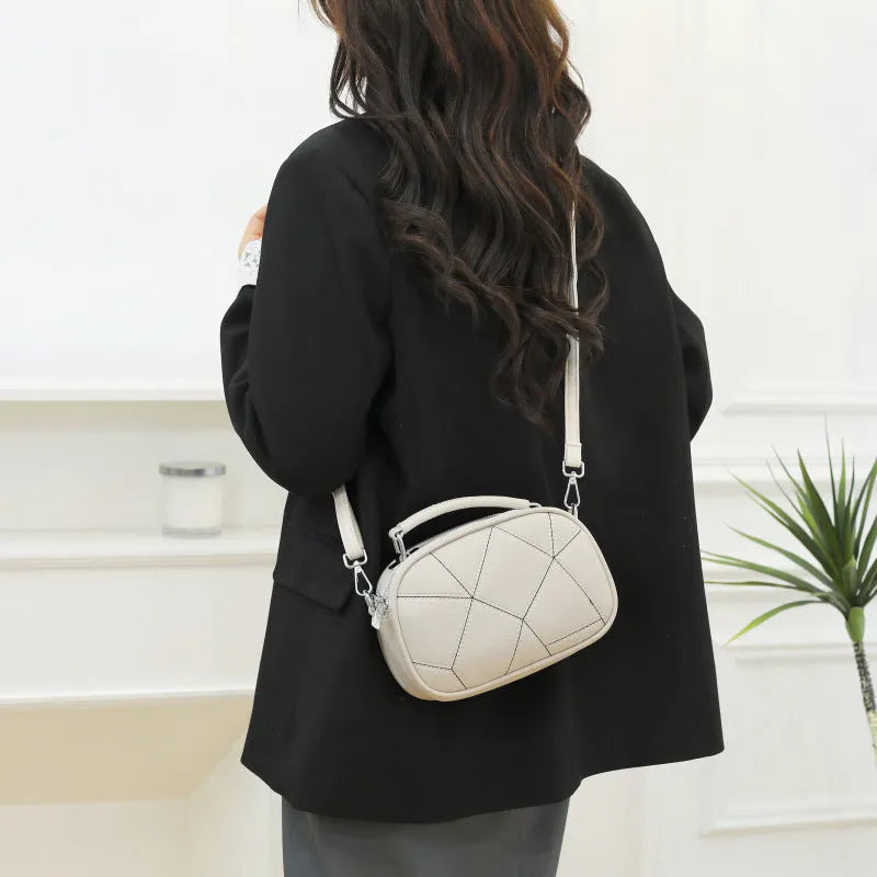 Gray three-layer patchwork small round bag with visible stitching, shown with beige, black, white, and blue colour options.
