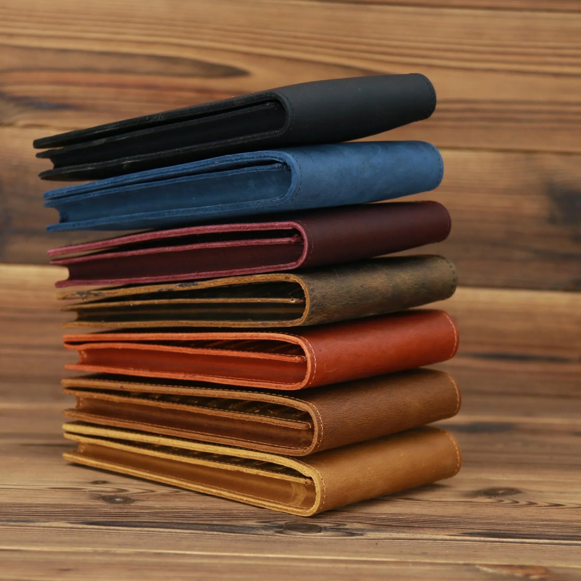Slim black leather men's wallet open to show 18 card slots and a central mobile phone pocket.
