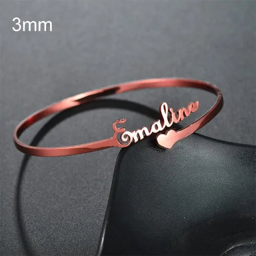 Personalised name bracelet in stainless steel with 10mm width, shown in silver, gold, or rose gold