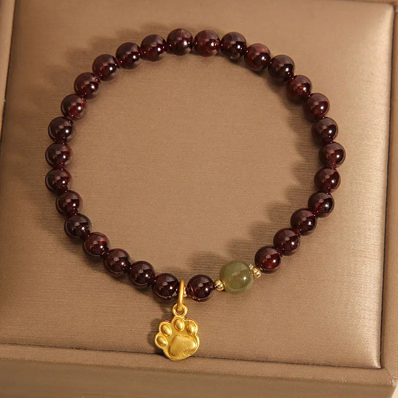 Cat's paw garnet crystal bracelet for women showing clear beads with feline charm