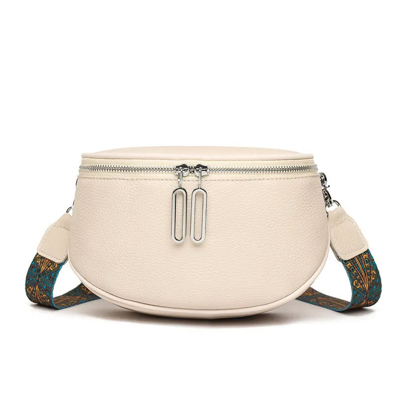 Women's saddle-shaped PU leather messenger bag in black colour with single shoulder strap and sewing line details