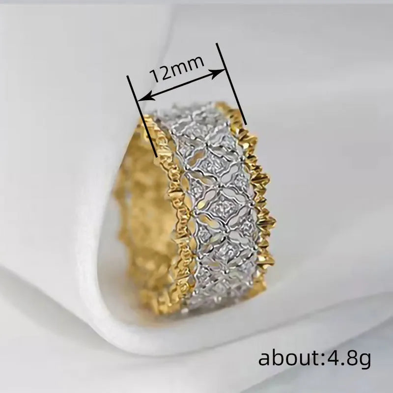 Geometric two-tone copper ring with a round central zircon stone, shown on a finger.