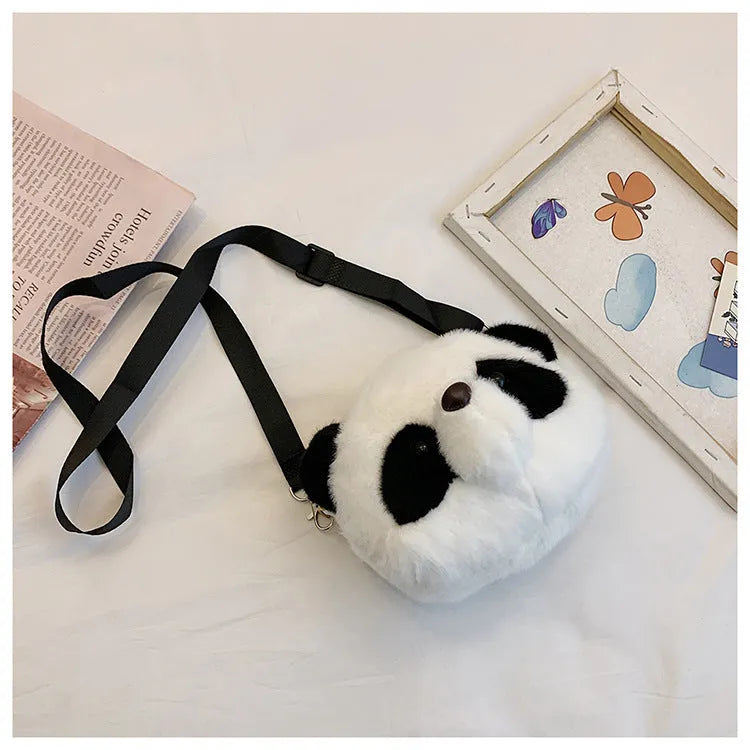 Soft plush panda head design crossbody bag showing cylindrical shape and outer pocket.