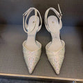 Women's black high heels with hollow design, red sole, and pointed toe on stiletto heel