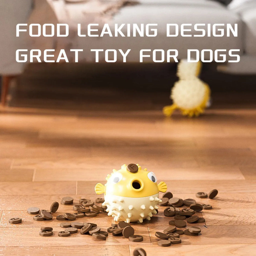 Yellow vinyl fish-shaped squeaky dog chew toy on a plain background
