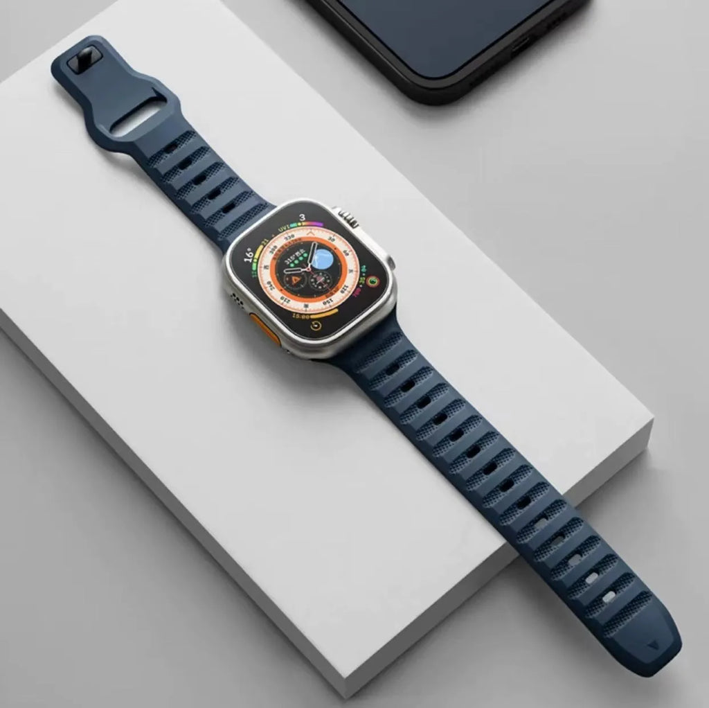 Fluoro rubber Apple Watch strap in multiple colours on a grey background, showing the T-buckle closure.