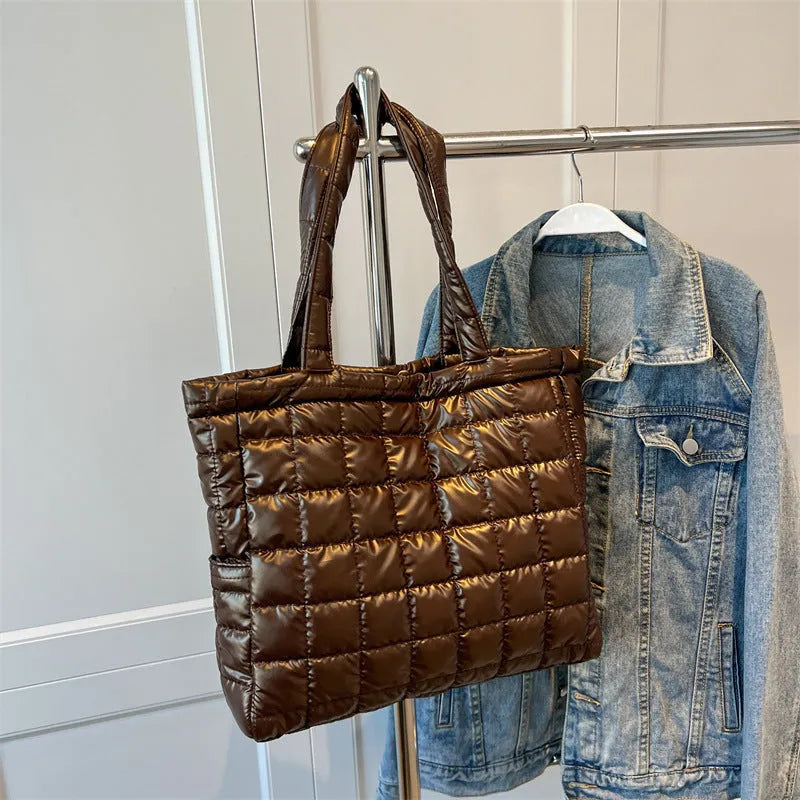 Large nylon plaid bucket shoulder bag in black with rhombus pattern, magnetic buckle, and soft handle.