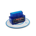 Small black ELM327 OBD2 Bluetooth car diagnostic scanner plugged into a vehicle port.