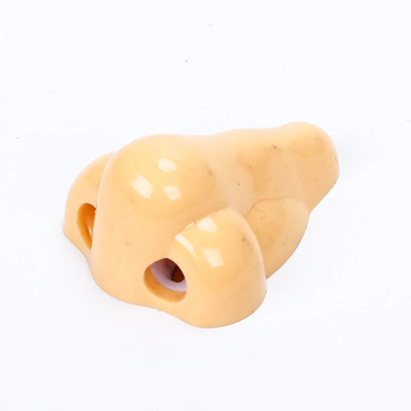 Flesh colour plastic manual pencil sharpener with big nostril and geometry shape.