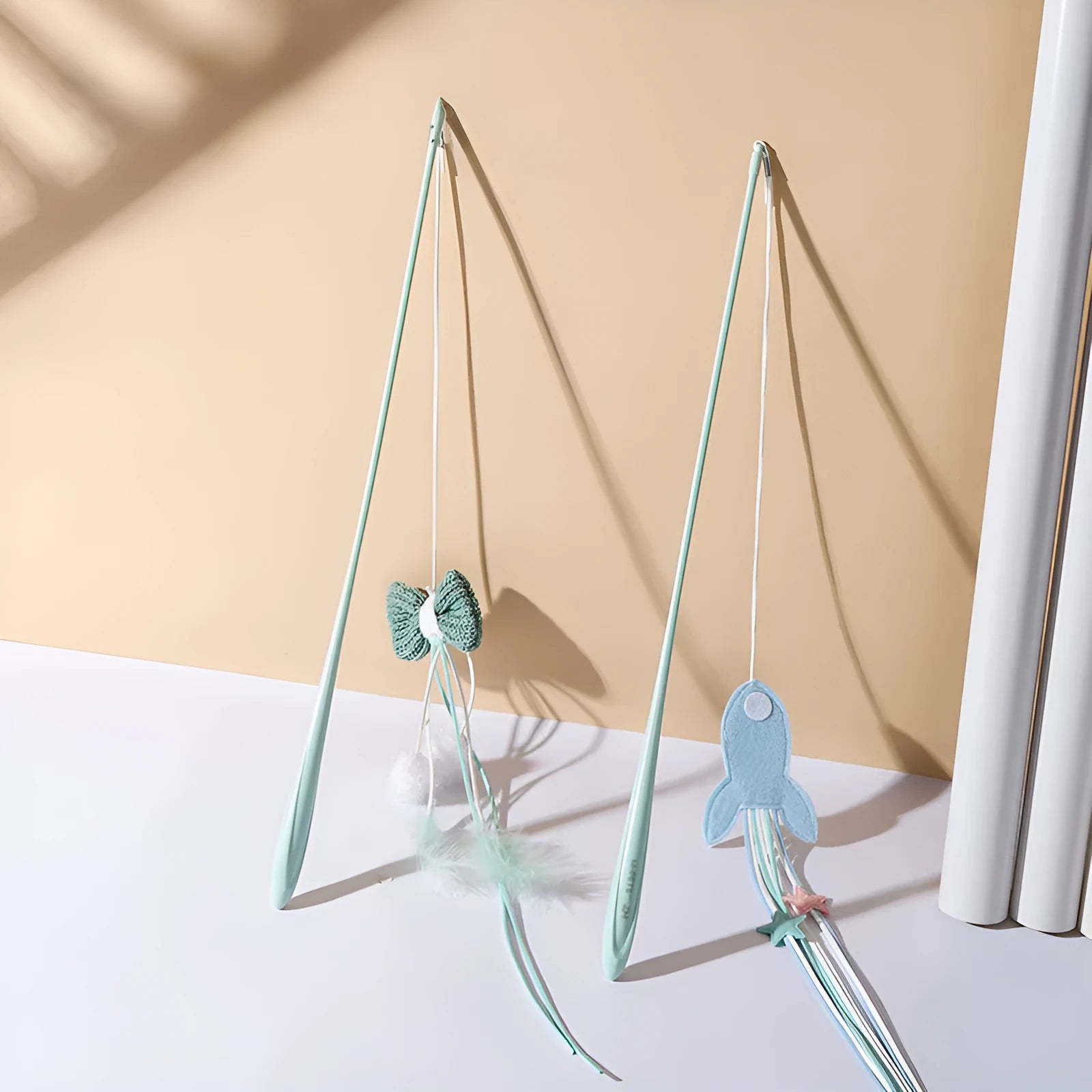 Blue long pole cat teaser toy with feather attachments and an inflated ego design element.