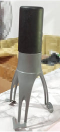 Green Uutensil Stirr automatic cooking mixer device next to a cooking pot.