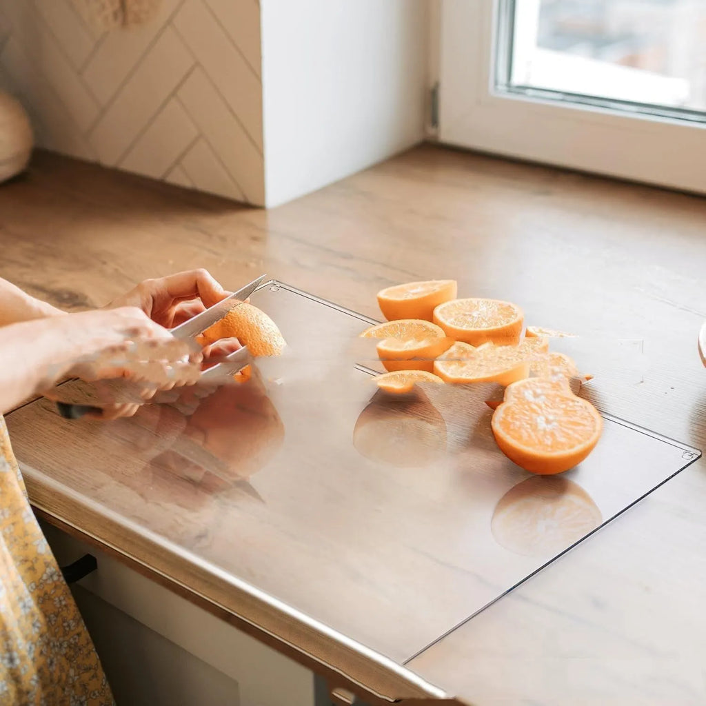 Black transparent acrylic chopping board in 30 x 20 cm size on a kitchen counter