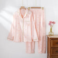 Women's pink cotton pajamas set with long sleeves and trousers on hanger