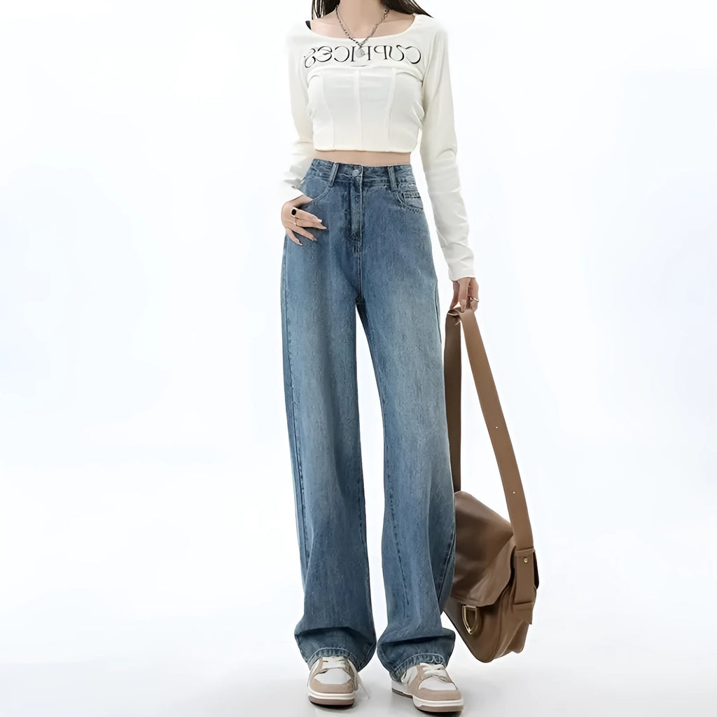 Woman wearing high-waisted retro blue wide leg jeans with a straight-leg cut.