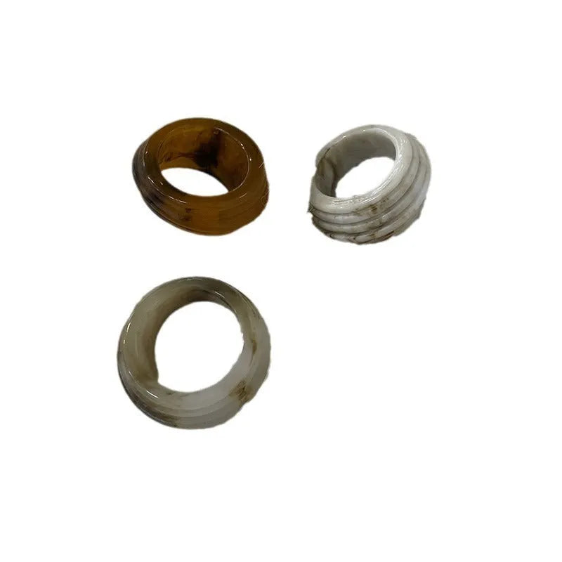 Geometric resin wide ring with irregular Chinese-inspired design in brown and white colours