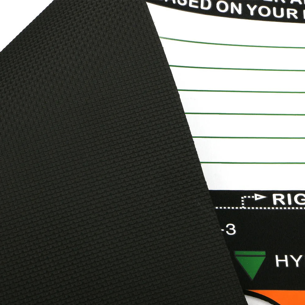 Black neoprene golf swing posture training pad on grass for stance alignment correction.