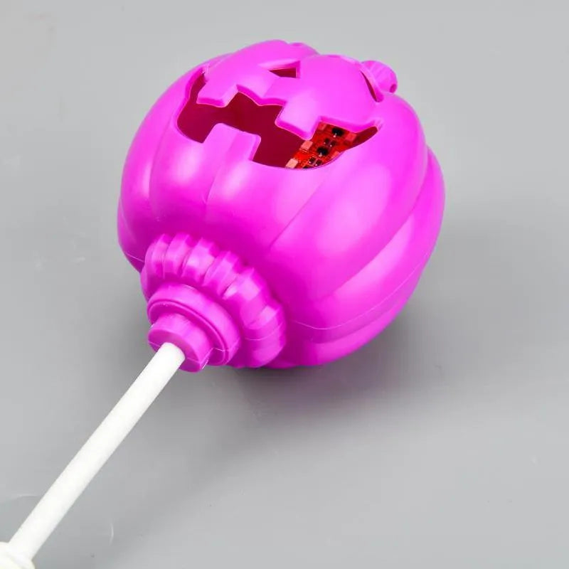 Plastic pumpkin lamp with USB power cable showing yellow or purple light options