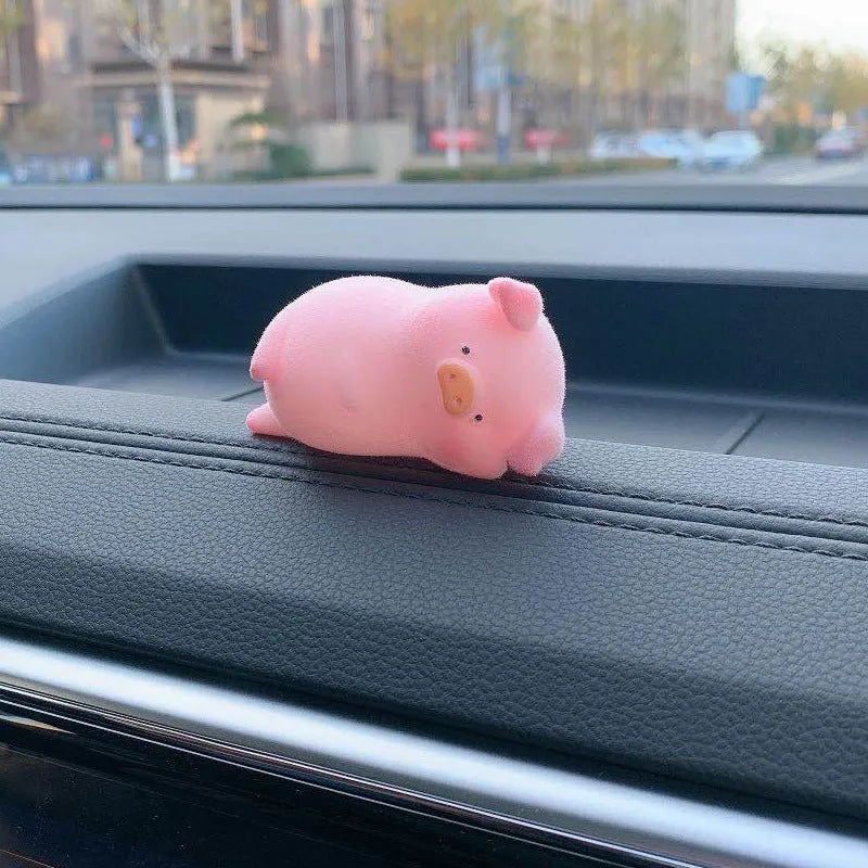 Set of eight cute cartoon pig resin car dashboard decorations on a car console