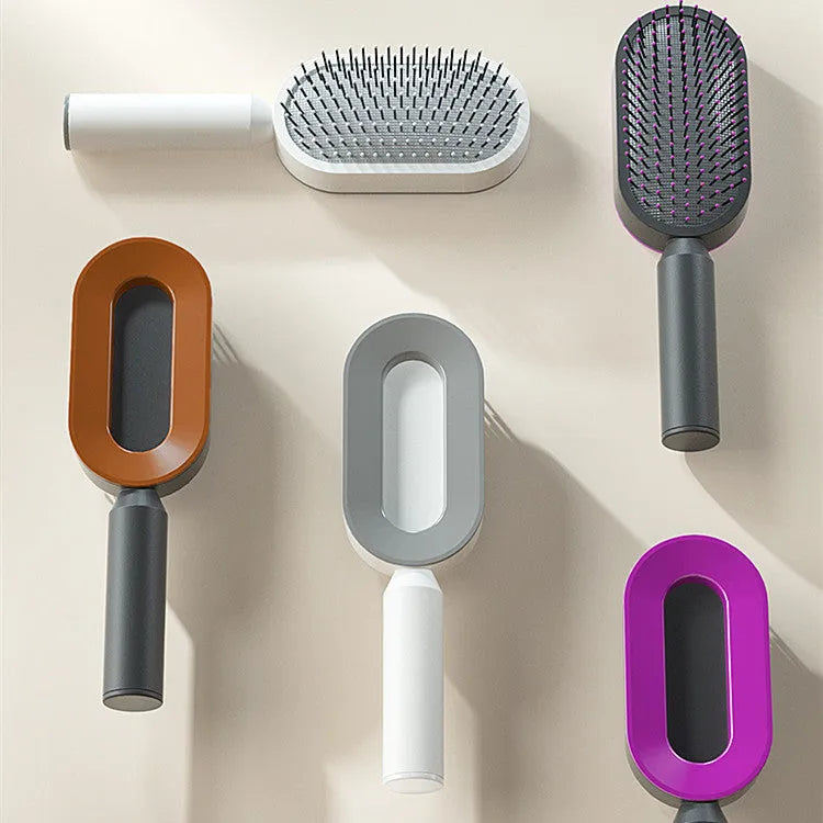 Self-cleaning air cushion hair brush in white, black gold, or black purple with ergonomic handle