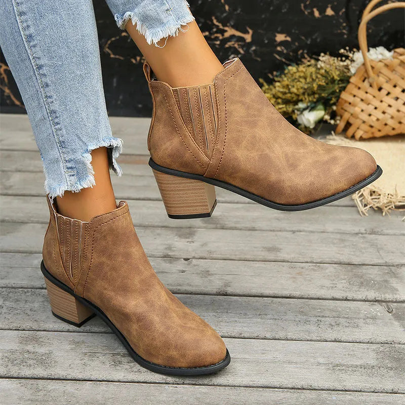 Women's black pointed toe ankle boots with thick square heel, slip-on design