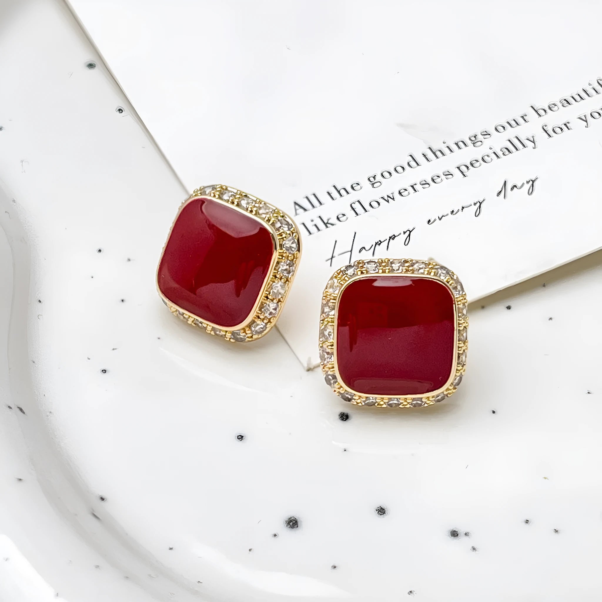 Red alloy square earrings with an inlaid geometric pattern, shown from the front.