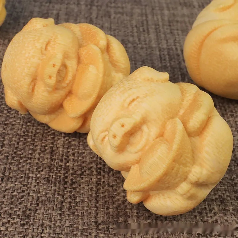 Solid bamboo carving ornament of cute pig figure measuring 4cm tall by 3.5cm diameter