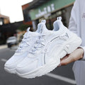 White women's casual sports shoes with mesh upper, thick PU sole, round toe, and a buckle strap.