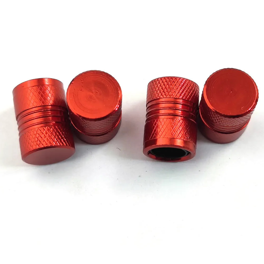 Aluminium car tyre valve cover in black, 17mm length, on a tyre valve stem