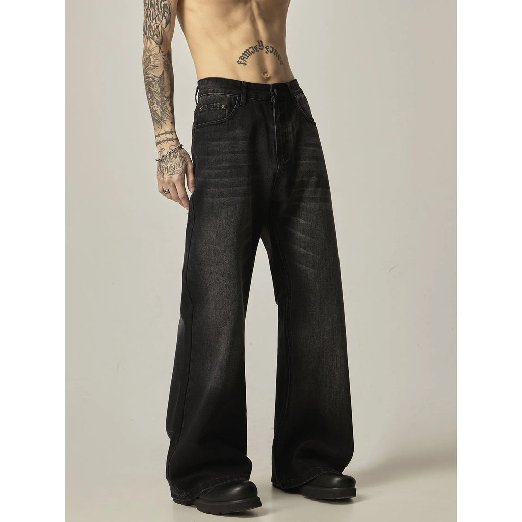 Black loose-fit straight-leg retro jeans with zipper fly on a plain background.