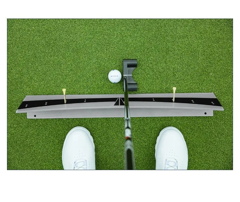 Adjustable golf putter trajectory balance simulator made from white PVC on a green mat.