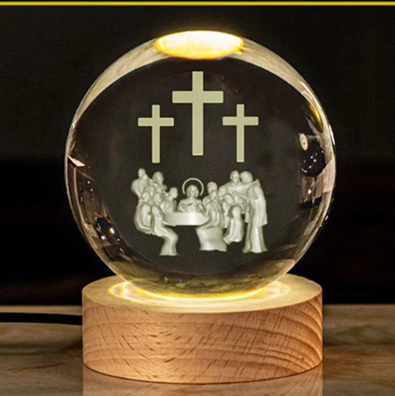 White crystal ball ornament with internal Christian cross figure on a wooden light-up base.