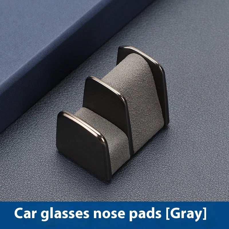 Zinc alloy and leather car dashboard glasses clip holder in green, shown on a car dashboard.