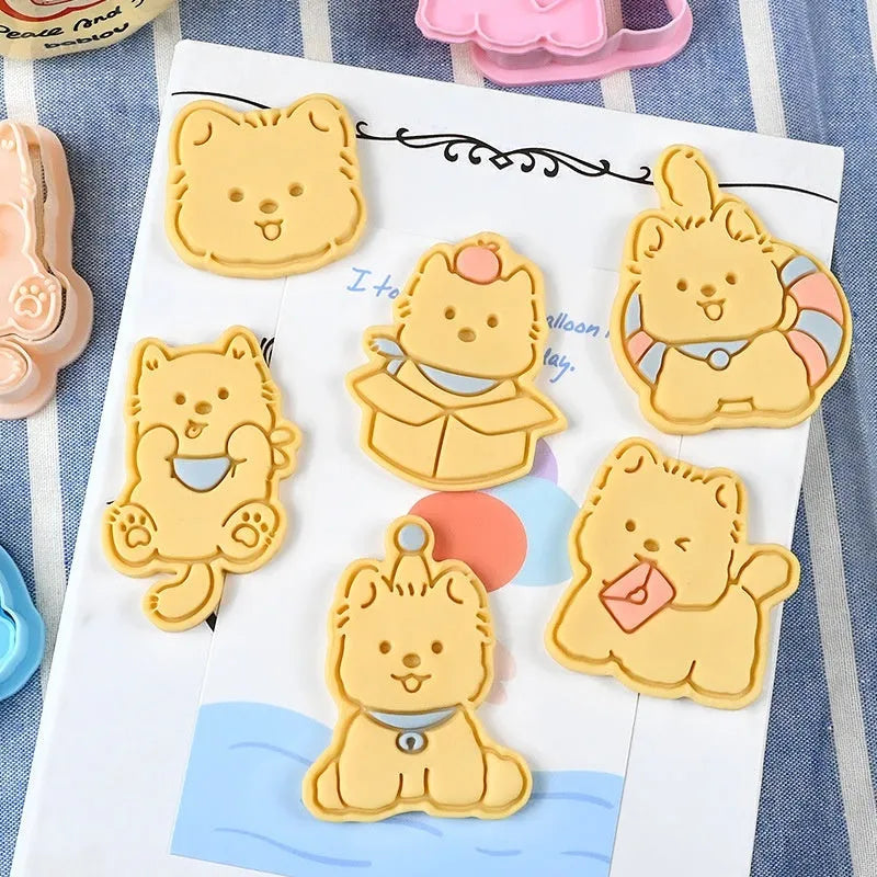 Plastic cartoon biscuit mould showing three-dimensional pet puppy designs including one with a birthday hat