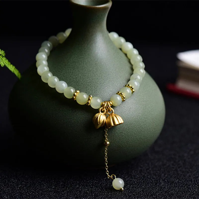 Natural Hetian Jade bracelet with Fu character detail on 6mm beads in a sunny water colour.