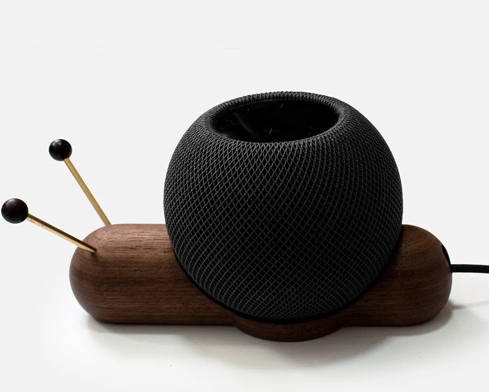 Coffee coloured non-slip desktop bracket for Apple HomePod speaker.