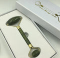 Xiuyu jade double-headed facial massage roller stick on white background
