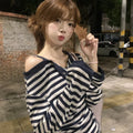 Dark blue Korean-style oversized women's long-sleeved t-shirt with stripes, buttons, and embroidery detail.