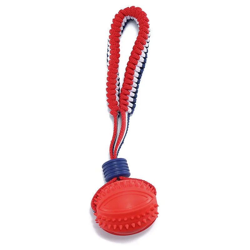Red rubber dog ball with rope attachment showing textured surface and 29cm total length