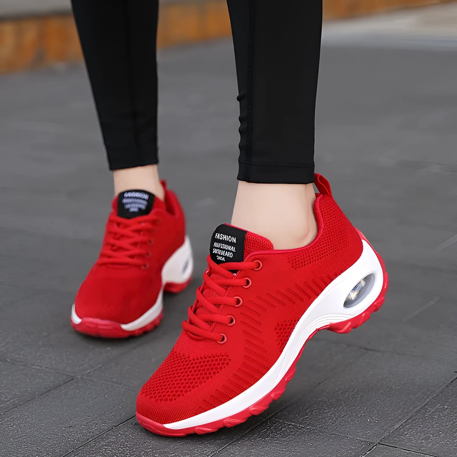 Black and red women's low-top mesh sneakers with round toe and lace-up front.