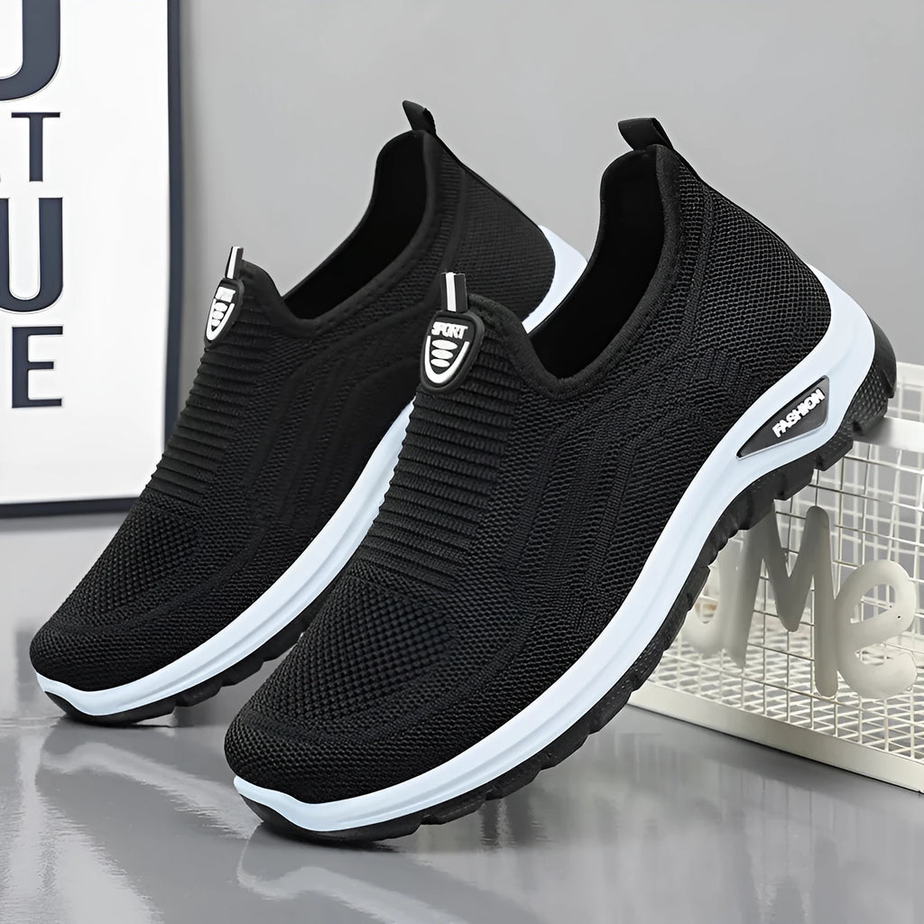 Men's black and grey casual tennis shoes with mesh lining and flat PVC sole.