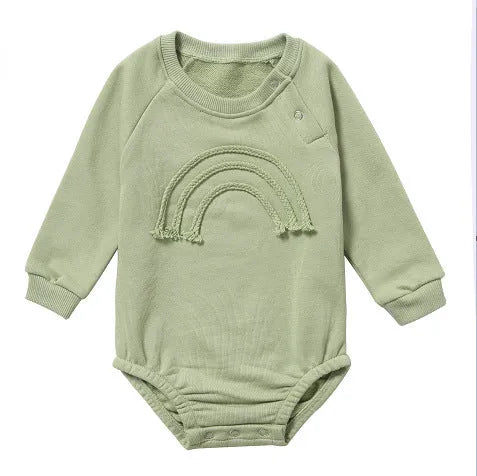 Neutral baby romper in waffle cotton fabric with long sleeves, shown in beige with cotton rope detail.