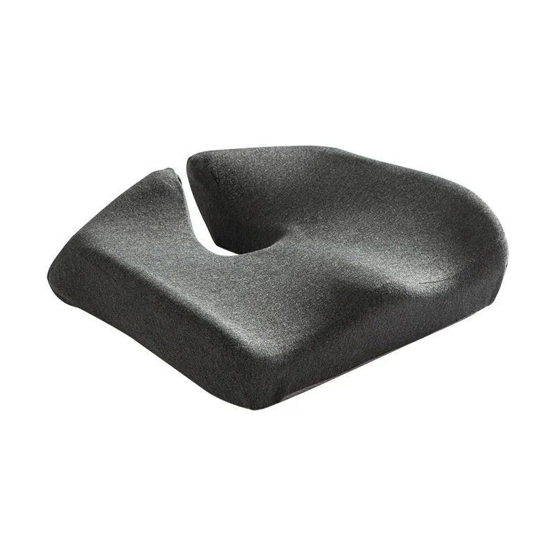 A black memory foam office chair cushion measuring 36 by 40 centimetres on a desk chair.