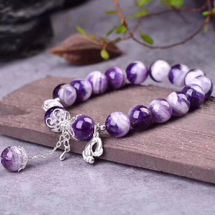 Amethyst bracelet for women with 10mm round beads on a wrist.