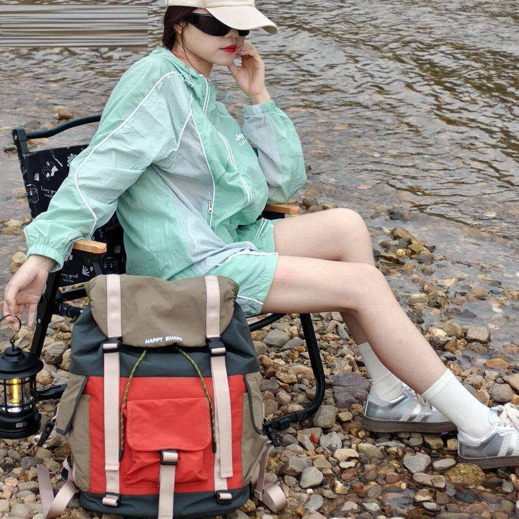 Orange-green contrast colour outdoor backpack with multiple compartments showing 35L capacity