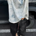 Plain solid colour loose fit t-shirt on a hanger, front view showing round neck and short sleeves.