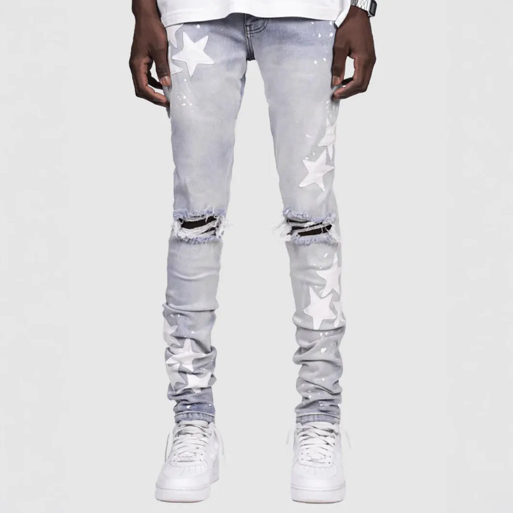 Men's slim blue jeans with embroidery detail on the leg, showing a mid-waist fit.