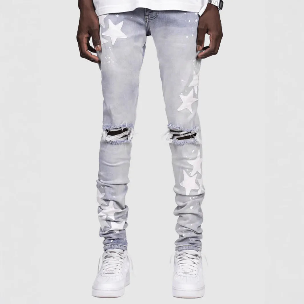 Men's slim blue jeans with embroidery detail on the leg, showing a mid-waist fit.