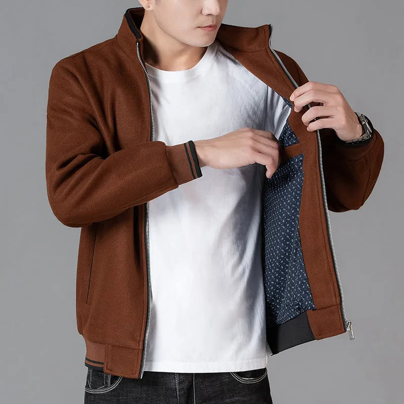 Men's grey sport fleece jacket with long sleeves and a stick pocket, shown on a hanger.